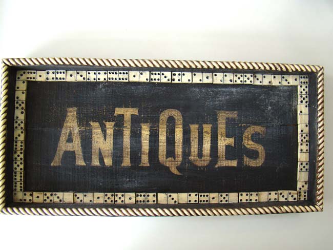An unusual 'Antiques' Trade Sign in the form of a tray banded with faux dominoes and faux bone edge